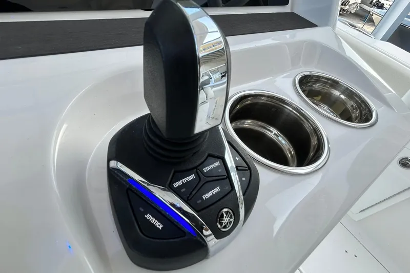 Slide: The Image of Joystick control on 2021 Edgewater 340CC boat console with cup holders. - 23
