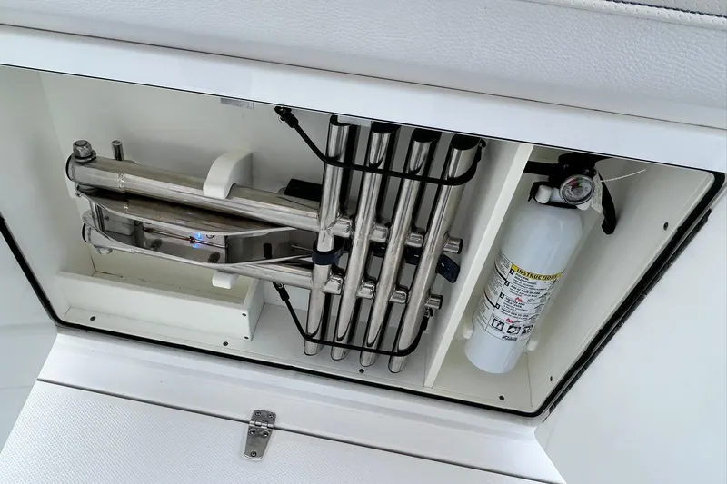 Slide: The Image of Storage compartment in 2021 Edgewater 340CC boat with ladder and fire extinguisher. - 29