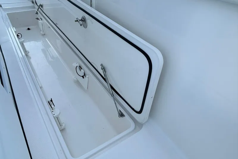 Slide: The Image of Open storage compartment on 2021 Edgewater 340CC boat, showcasing interior details. - 30