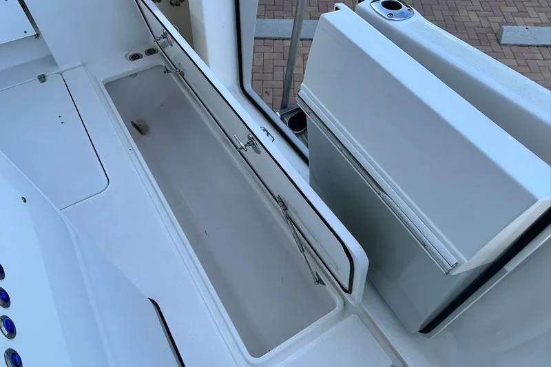 Slide: The Image of 2021 Edgewater 340CC boat storage compartment with open hatch, showcasing spacious interior. - 31