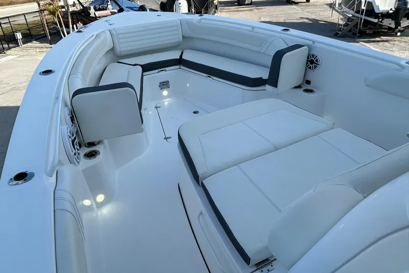 Slide: The Image of Luxurious seating area on 2021 Edgewater 340CC boat, featuring sleek white upholstery. - 32