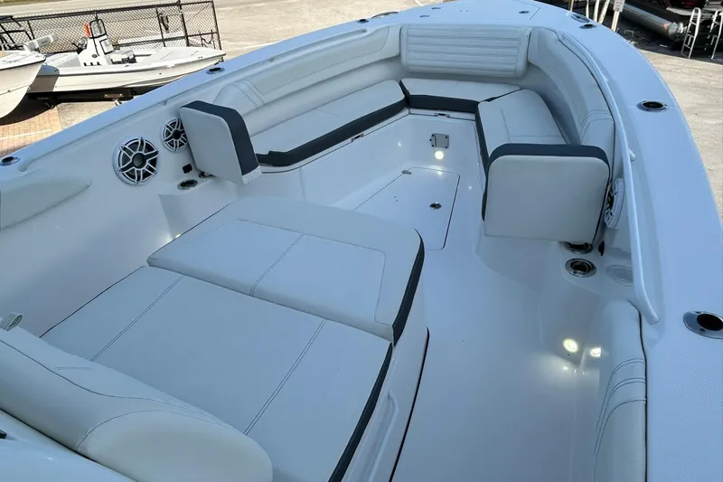 Slide: The Image of 2021 Edgewater 340CC boat interior with white seating and built-in speakers. - 33