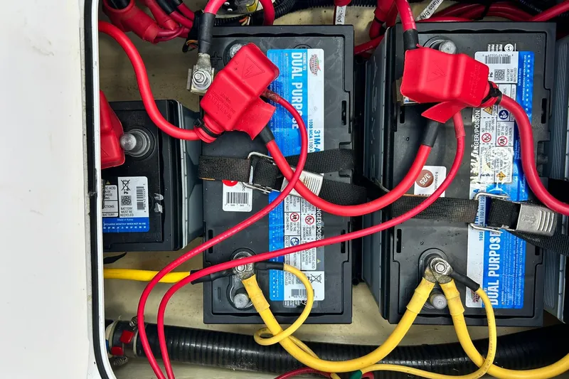 Slide: The Image of Battery compartment of a 2021 Edgewater 340CC boat with red and yellow cables. - 36