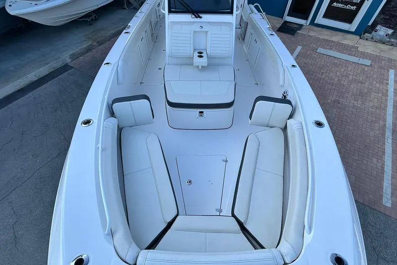 Slide: The Image of 2021 Edgewater 340CC boat interior with white seating and spacious deck layout. - 38