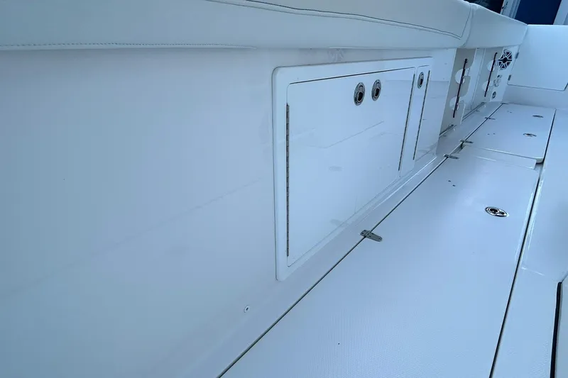 Slide: The Image of 2021 Edgewater 340CC boat interior with storage compartments and seating. - 41
