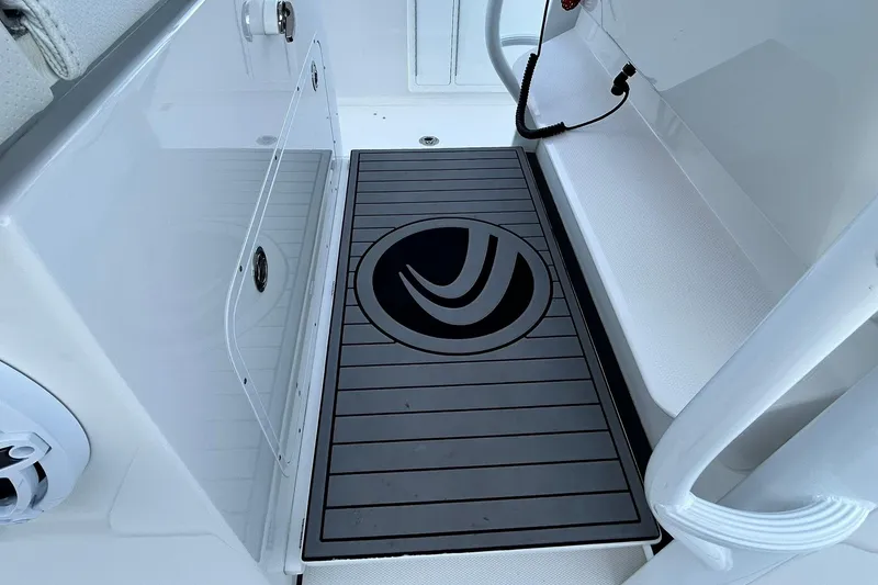 Slide: The Image of 2021 Edgewater 340CC boat interior with sleek flooring and storage compartments. - 43