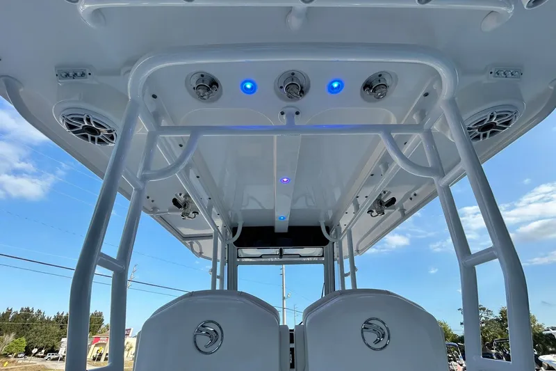 Slide: The Image of 2021 Edgewater 340CC boat interior with blue LED lights and speakers. - 45