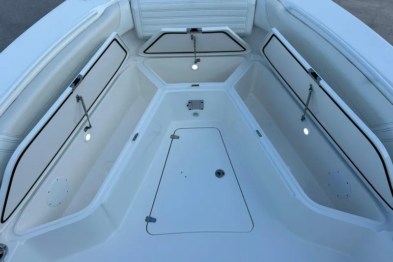 Slide: The Image of 2021 Edgewater 340CC boat interior with open storage compartments and seating. - 46
