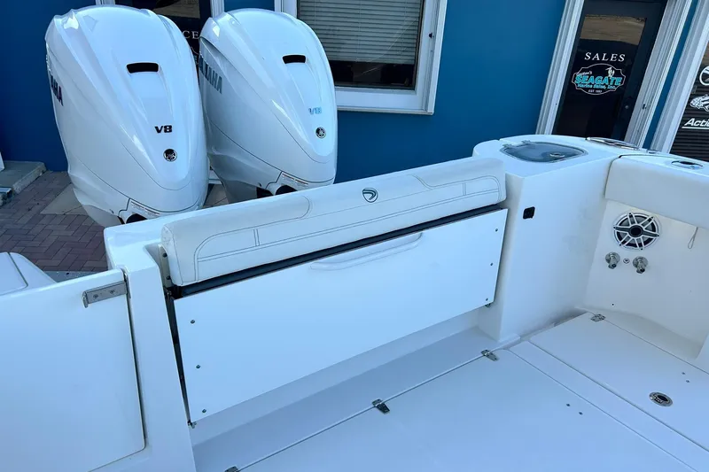 Slide: The Image of 2021 Edgewater 340CC boat with twin Yamaha V8 engines, white interior, and speaker system. - 5