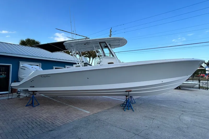 Slide: The Image of 2021 Edgewater 340CC boat on display, featuring sleek design and Yamaha engines. - 51