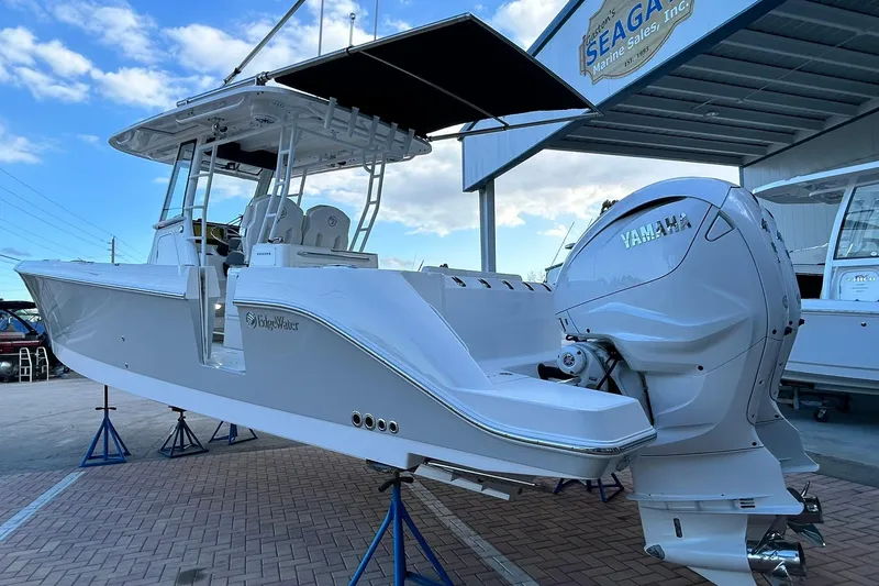 Slide: The Image of 2021 Edgewater 340CC boat with Yamaha engine displayed at a marine sales facility. - 57
