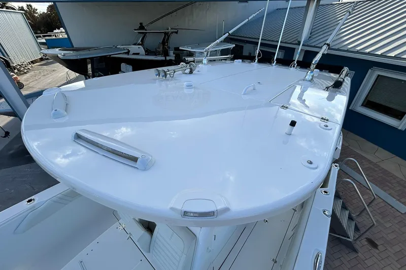 Slide: The Image of 2021 Edgewater 340CC boat deck with fishing rod holders and sleek design. - 59