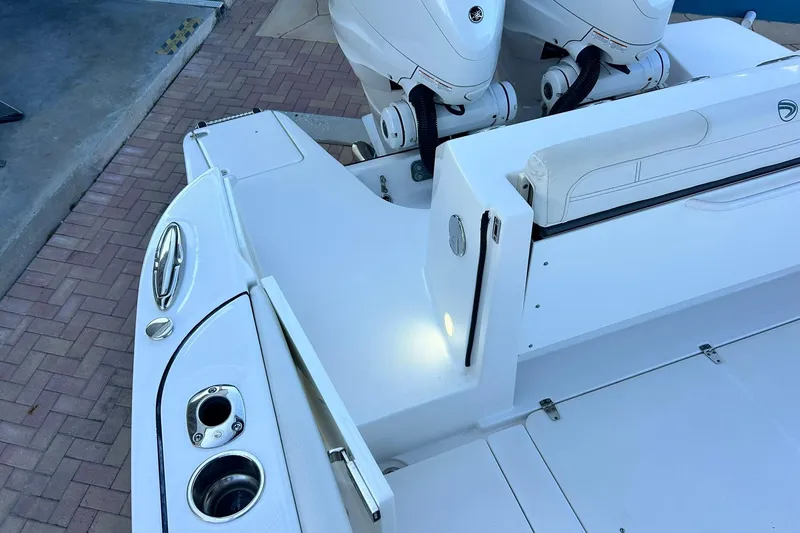 Slide: The Image of 2021 Edgewater 340CC boat deck with dual engines and seating area. - 6