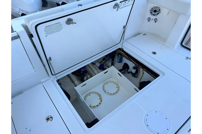 Slide: The Image of 2021 Edgewater 340CC boat storage compartment with open hatch and visible equipment. - 7