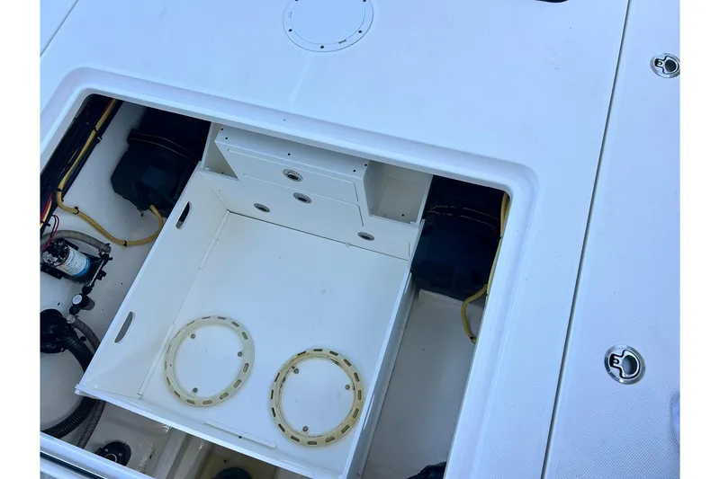 Slide: The Image of 2021 Edgewater 340CC boat storage compartment with wiring and equipment. - 8