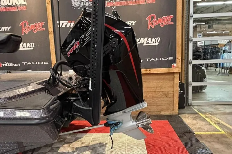 Slide: The Image of 2025 Triton 20XP Patriot boat with Mercury Pro XS engine in showroom. - 3