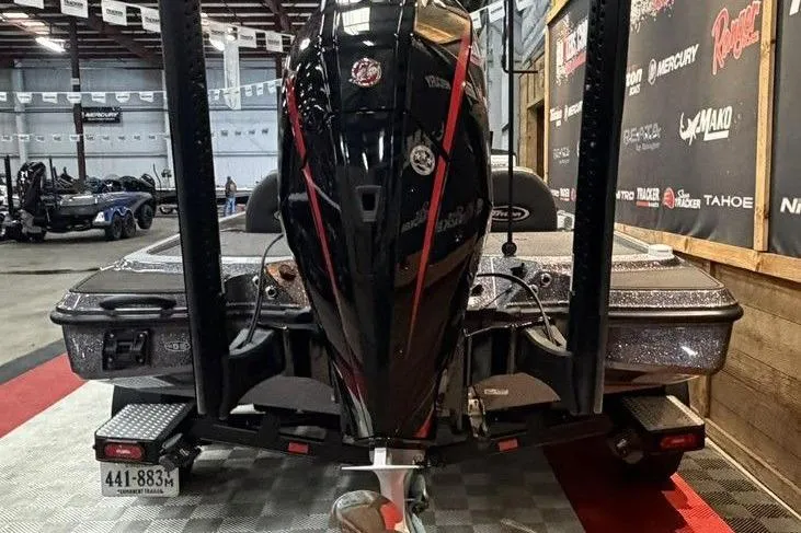 Slide: The Image of 2025 Triton 20XP Patriot boat displayed indoors, showcasing powerful engine and sleek design. - 6