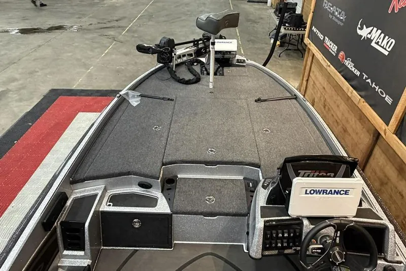 Slide: The Image of 2025 Triton 20XP Patriot boat interior with Lowrance electronics, showcased indoors. - 8