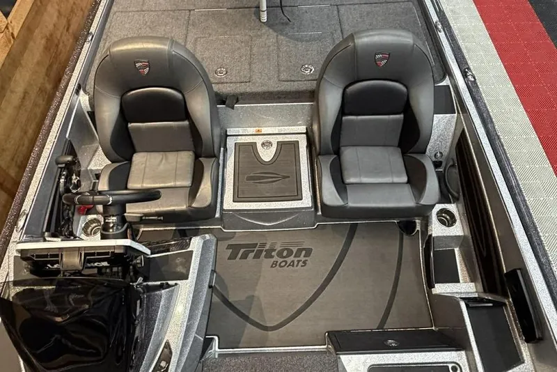 Slide: The Image of 2025 Triton 20XP Patriot boat interior with dual seats and steering console. - 9