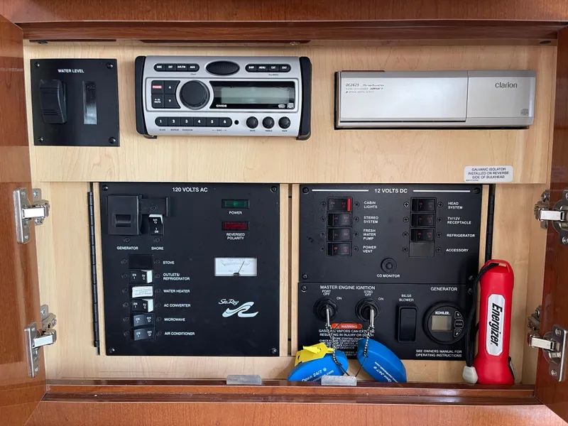 Slide: The Image of Control panel of a 2005 Sea Ray Amberjack 290 boat with stereo and electrical switches. - 14
