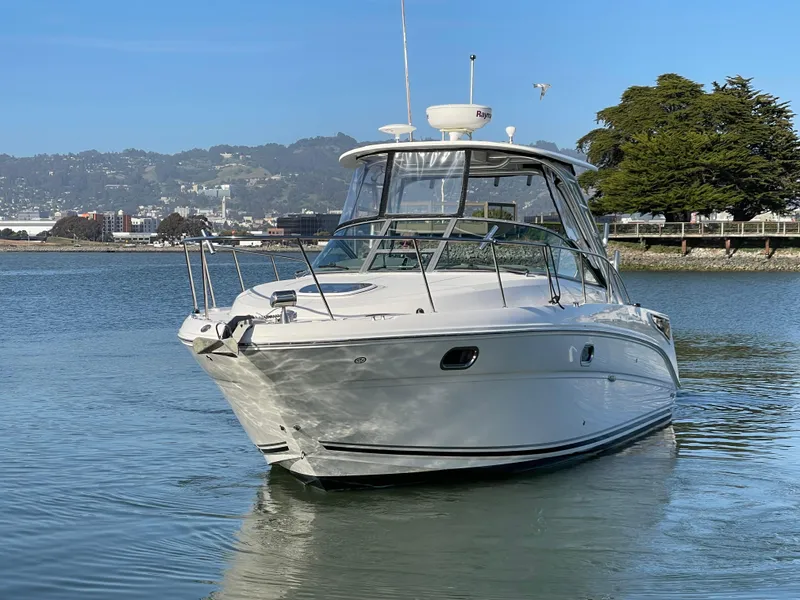 Slide: The Image of 2005 Sea Ray Amberjack 290 boat on calm water, scenic background. - 3
