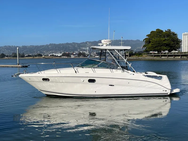 Slide: The Image of 2005 Sea Ray Amberjack 290 boat on calm water, clear sky background. - 5