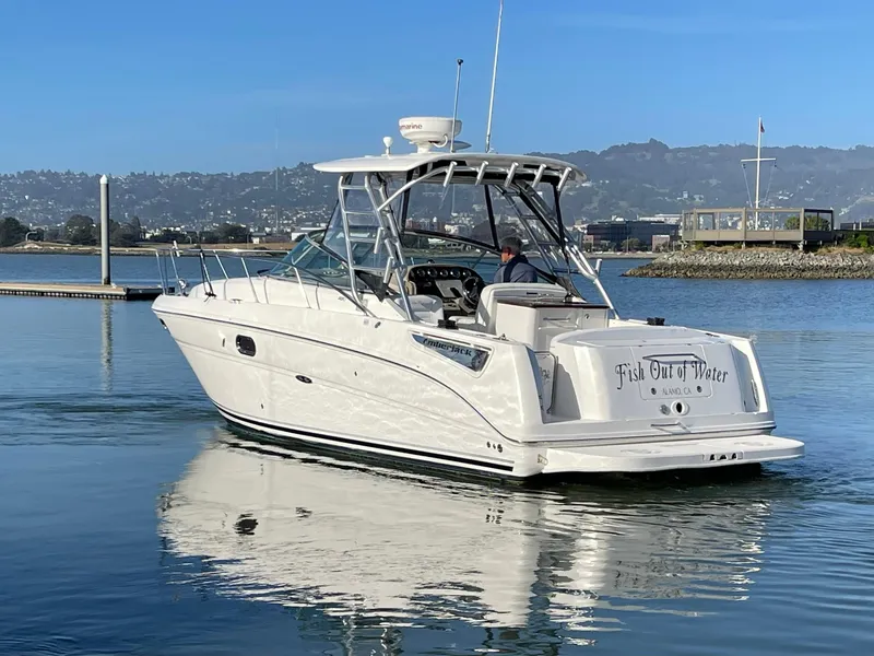 Slide: The Image of 2005 Sea Ray Amberjack 290 boat on calm water, with scenic background. - 6