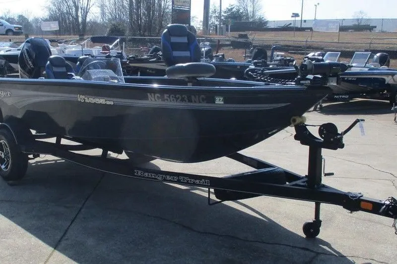 The Image of 2024 Ranger VS1665SC fishing boat on trailer in outdoor showroom. - 0