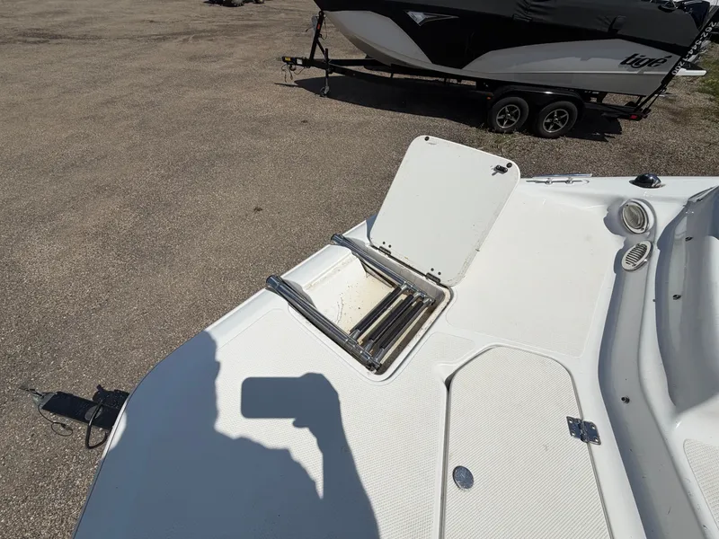 Slide: The Image of Hurricane 202 Sundeck Sport 2014 on a parking lot with open hatch. - 20