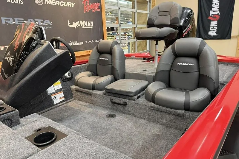Slide: The Image of 2026 Tracker Pro Team 190 boat interior with gray seating and steering console. - 10