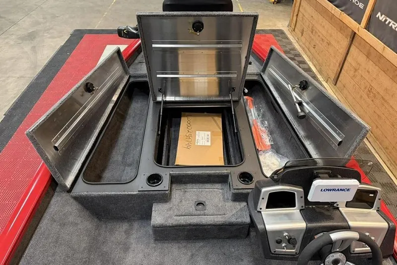 Slide: The Image of 2026 Tracker Pro Team 190 boat interior with storage compartments and Lowrance electronics. - 13