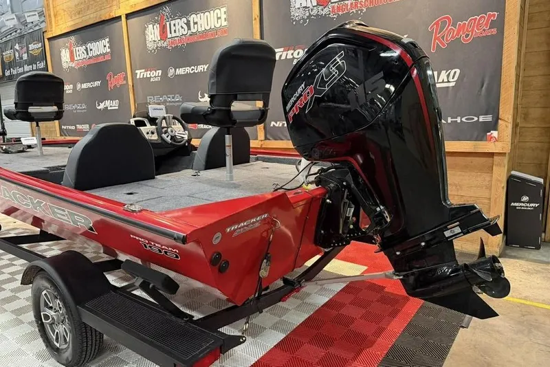 Slide: The Image of 2026 Tracker Pro Team 190 boat with Mercury Pro XS engine in showroom. - 5