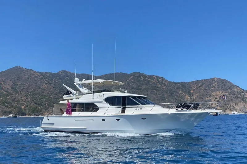 The Image of 1997 West Bay Sonship yacht cruising near scenic coastal mountains. - 0