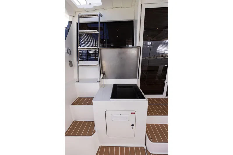 Slide: The Image of 1997 West Bay Sonship yacht interior with ladder and built-in grill on deck. - 10