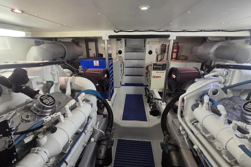 Slide: The Image of Engine room of 1997 West Bay Sonship yacht, featuring Onan generator and mechanical components. - 19