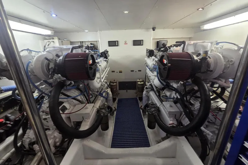 Slide: The Image of Engine room of a 1997 West Bay Sonship yacht, featuring dual engines and clean layout. - 21