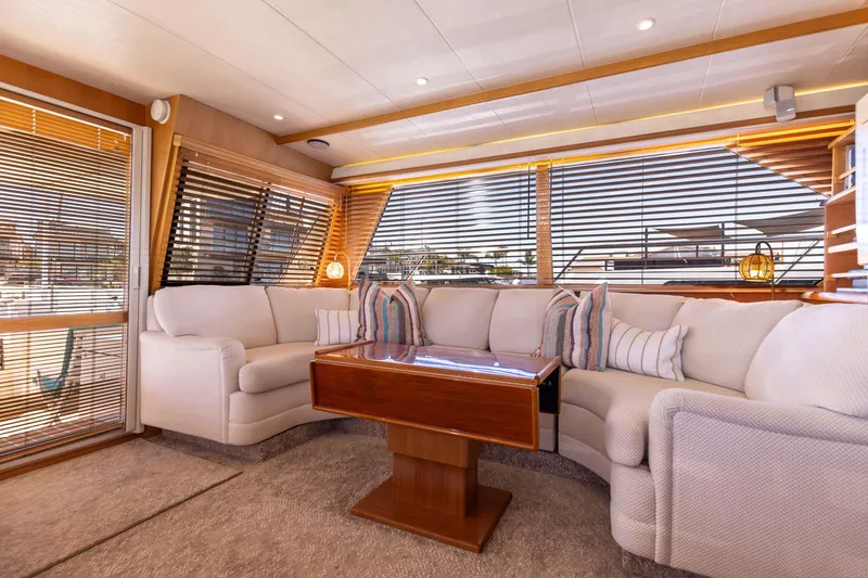 Slide: The Image of Luxurious 1997 West Bay Sonship yacht interior with plush seating and elegant wooden table. - 26