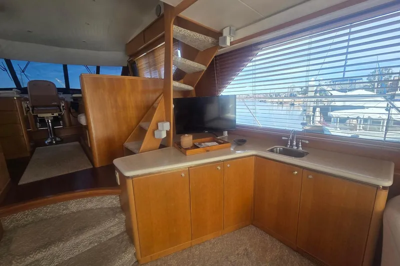 Slide: The Image of Luxurious 1997 West Bay Sonship yacht interior with wooden cabinetry and marina view. - 28