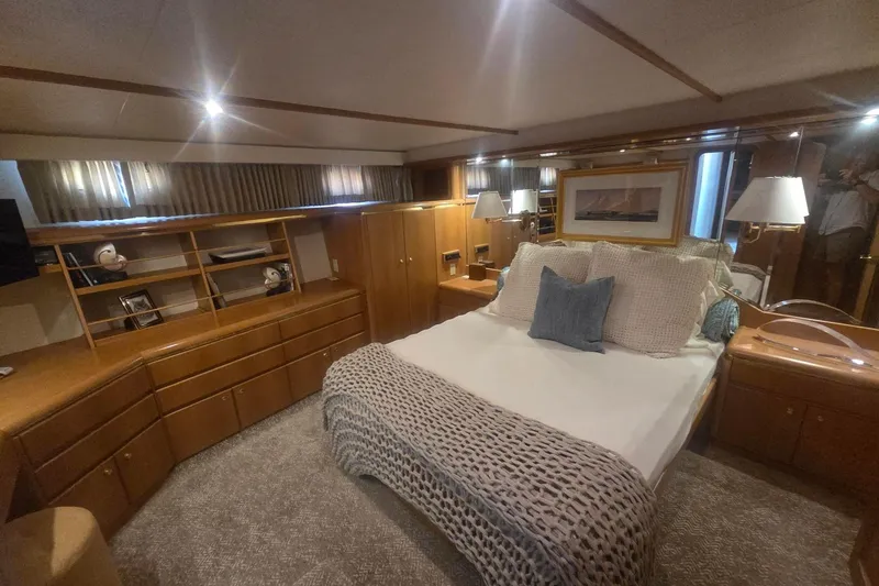 Slide: The Image of Luxurious 1997 West Bay Sonship yacht bedroom with elegant wood furnishings and cozy bedding. - 36