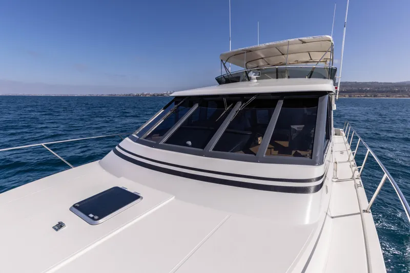Slide: The Image of 1997 West Bay Sonship yacht cruising on open water under clear blue skies. - 7