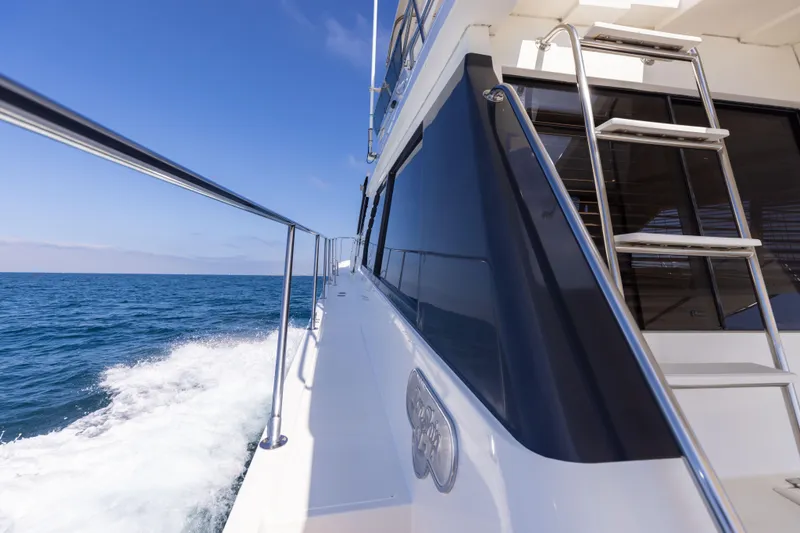 Slide: The Image of 1997 West Bay Sonship yacht cruising on open sea under clear blue sky. - 9