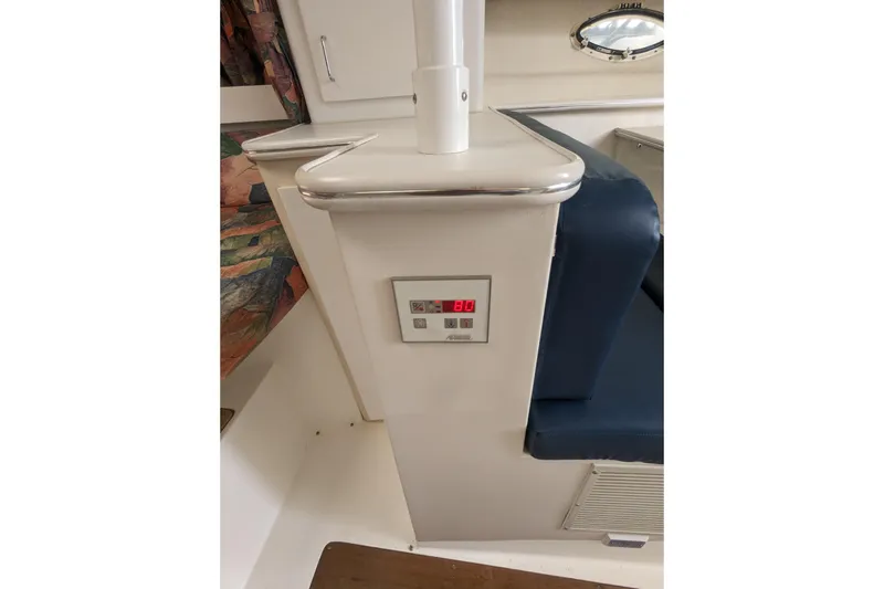 Slide: The Image of Interior of a 1995 Wellcraft 330 Coastal boat, featuring a control panel and seating. - 12