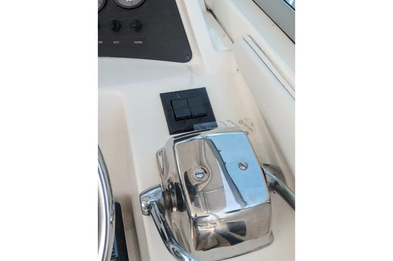 Slide: The Image of 1995 Wellcraft 330 Coastal boat control panel with chrome throttle lever. - 18