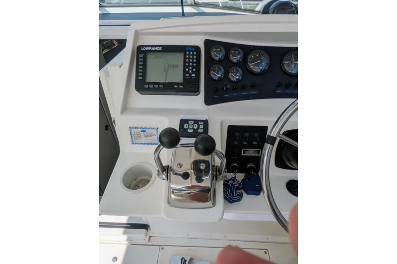Slide: The Image of 1995 Wellcraft 330 Coastal boat dashboard with controls and navigation equipment. - 19