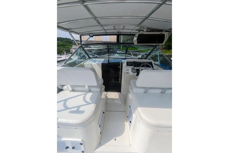 Slide: The Image of 1995 Wellcraft 330 Coastal boat interior with helm and seating area. - 21