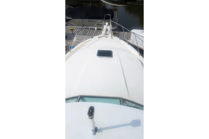 Slide: The Image of 1995 Wellcraft 330 Coastal boat docked, view from bow deck. - 28