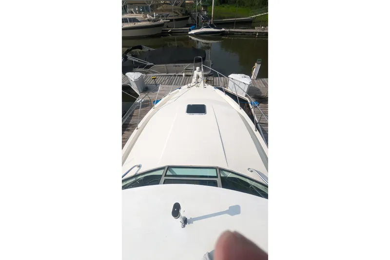 Slide: The Image of 1995 Wellcraft 330 Coastal boat docked at marina, top view of bow and deck. - 29