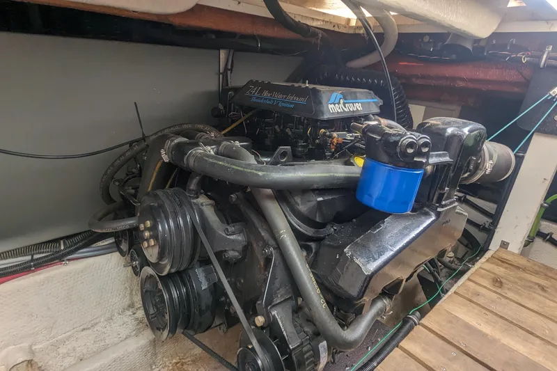 Slide: The Image of Engine compartment of a 1995 Wellcraft 330 Coastal boat, featuring a MerCruiser engine. - 32