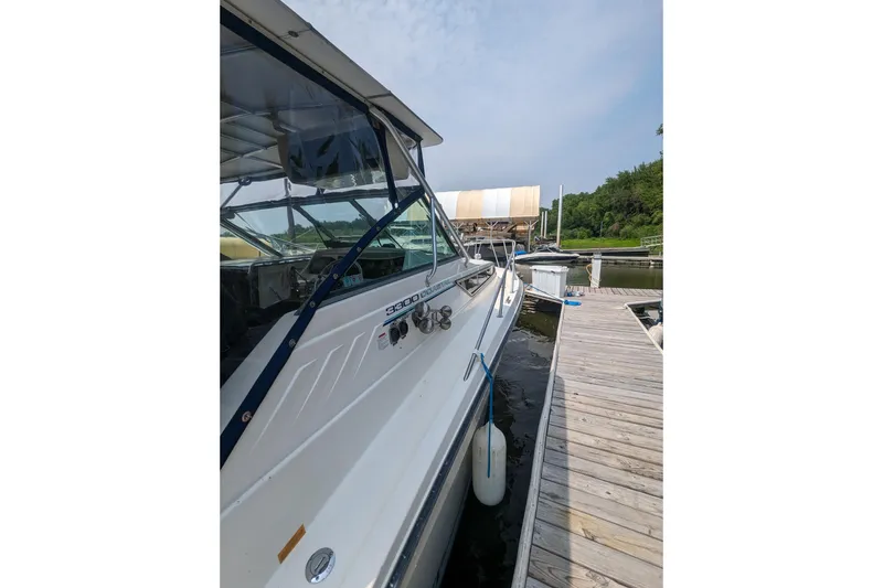 Slide: The Image of 1995 Wellcraft 330 Coastal boat docked at marina, side view. - 4