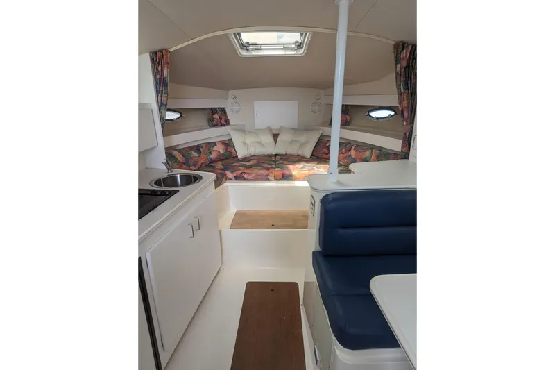 Slide: The Image of Interior of 1995 Wellcraft 330 Coastal boat with cozy seating and kitchenette. - 6